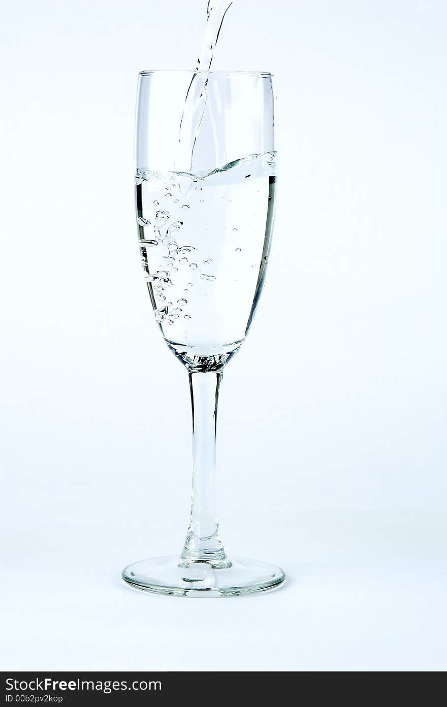 Puring water in glass, isolated on gradient background. Puring water in glass, isolated on gradient background