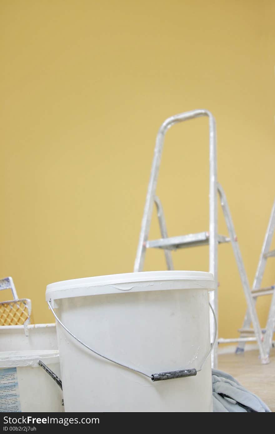 White pail an orange wall. White pail an orange wall.