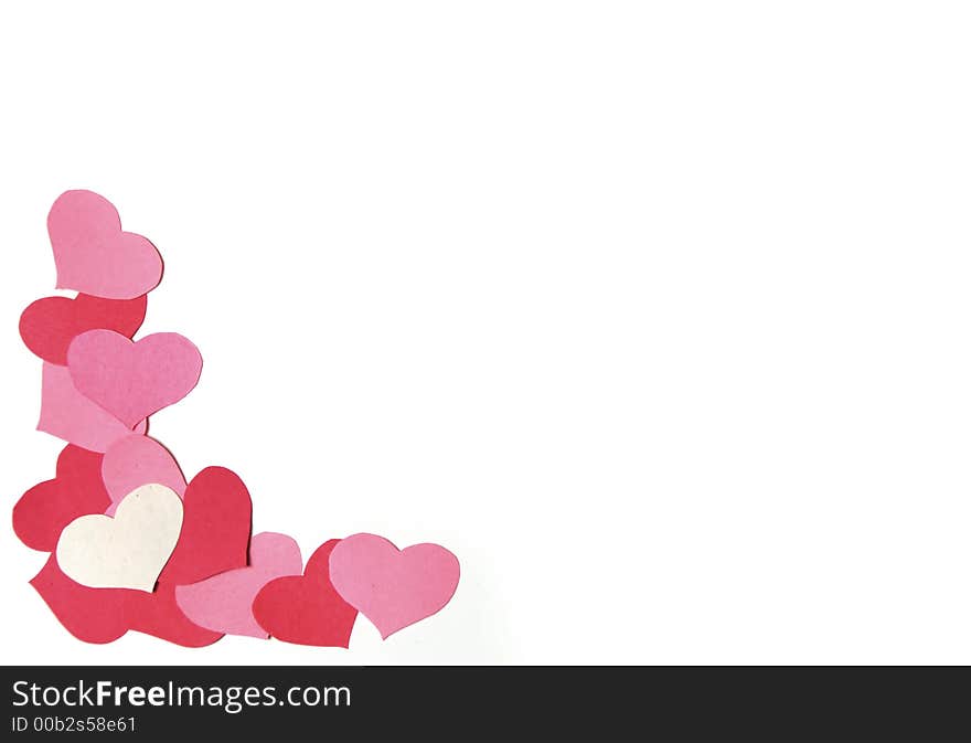 Cutout paper hearts aranged on a white background. Cutout paper hearts aranged on a white background