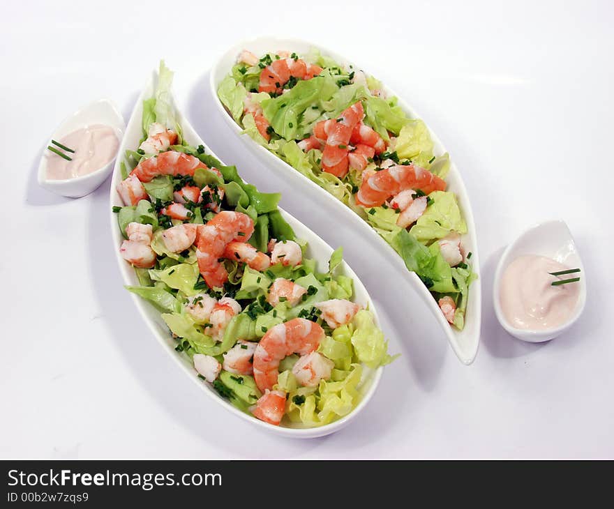 Shrimp salad in a white exclusives plates with sauce