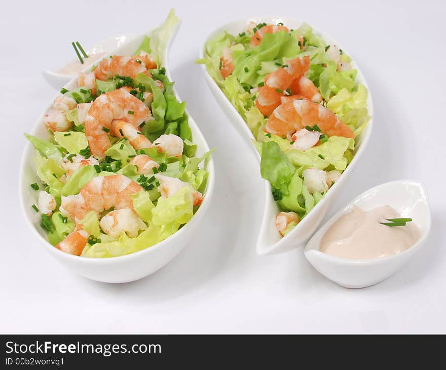 Shrimp salad in a white exclusives plates with sauce