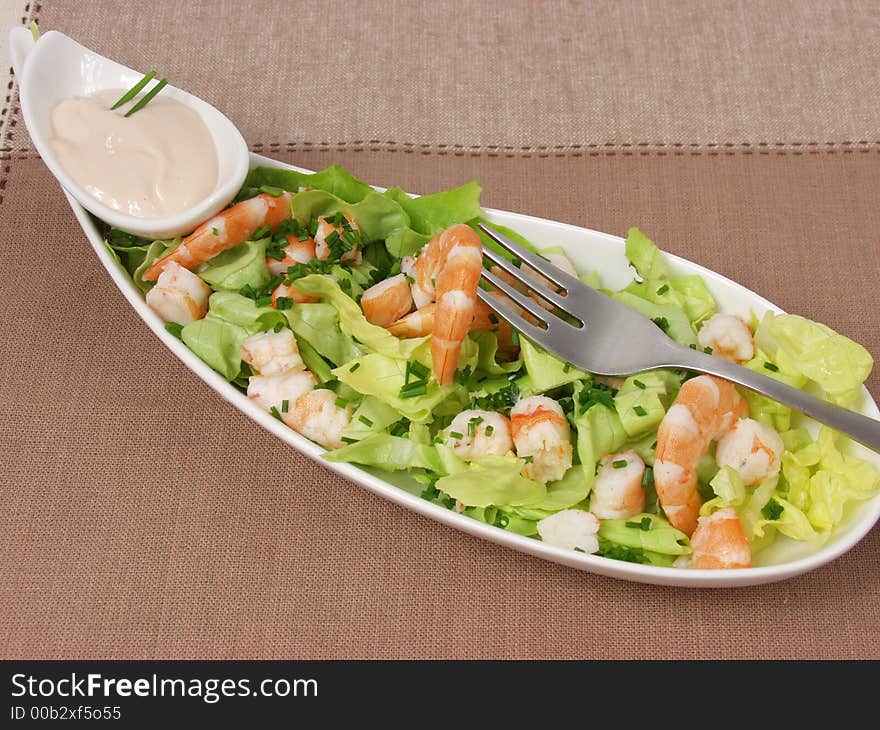 Shrimp salad in a white exclusives plates with sauce