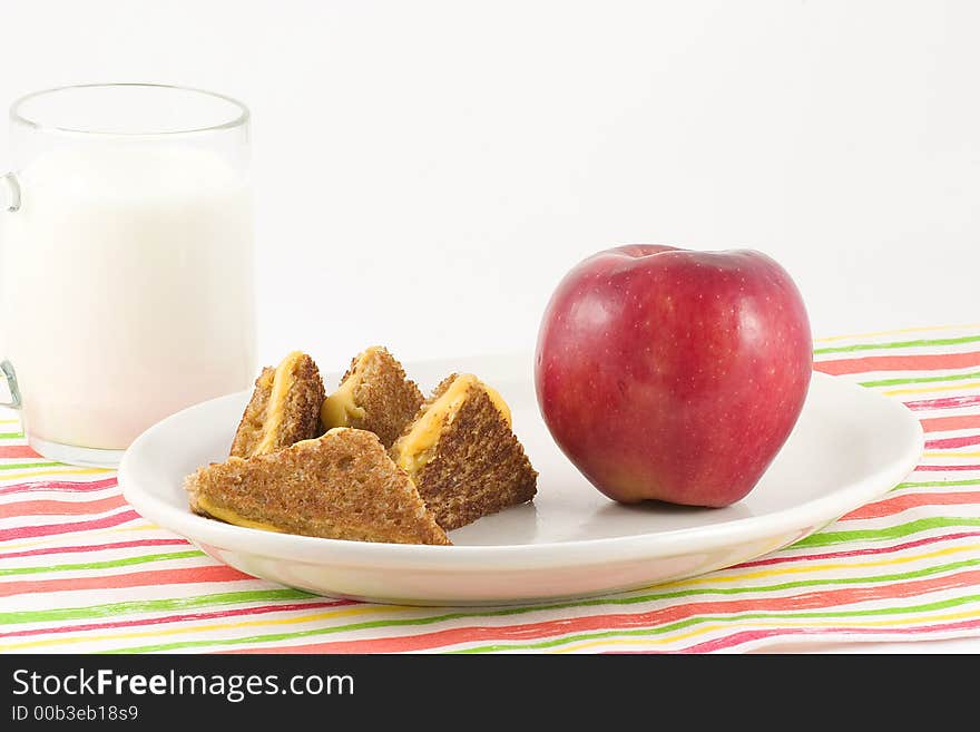 Brown bread,cheese,apple,milk and a colorful mat make a nutritious lunch or dinner special for the little ones. Brown bread,cheese,apple,milk and a colorful mat make a nutritious lunch or dinner special for the little ones.