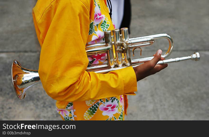 Close-up of a younng band member holding a trumpet