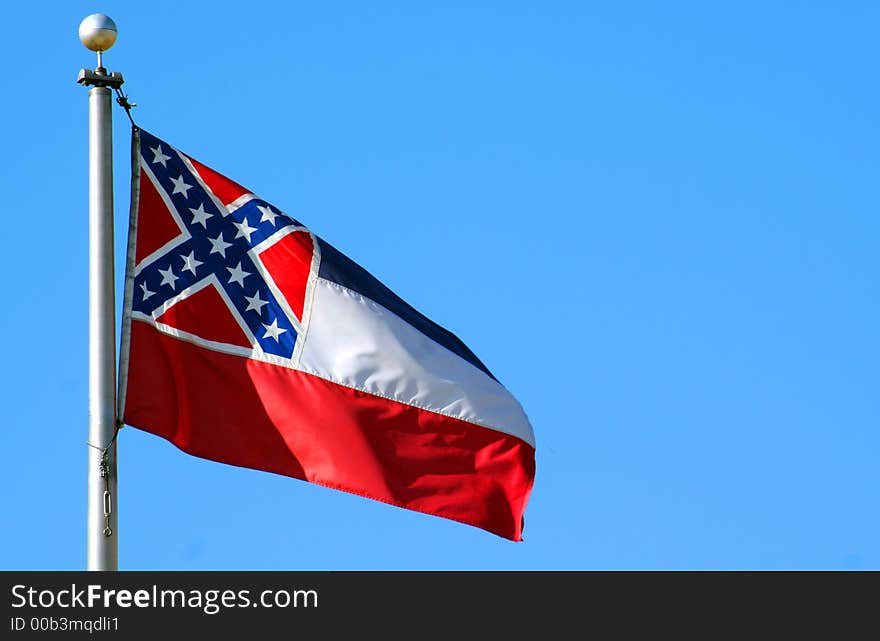 The state flage of Mississippi against a blue sky. The state flage of Mississippi against a blue sky.