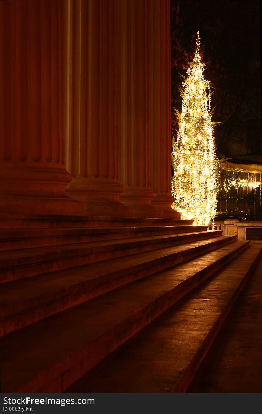 Night scene with Christmas tree in front of an old building columns and stairs. Night scene with Christmas tree in front of an old building columns and stairs