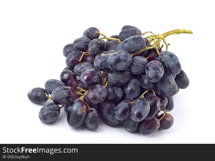 Bunch of red grapes with drops of water on a white background