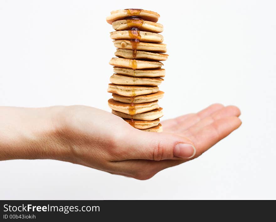 Isolated hand holding a huge stack of pancakes. Isolated hand holding a huge stack of pancakes