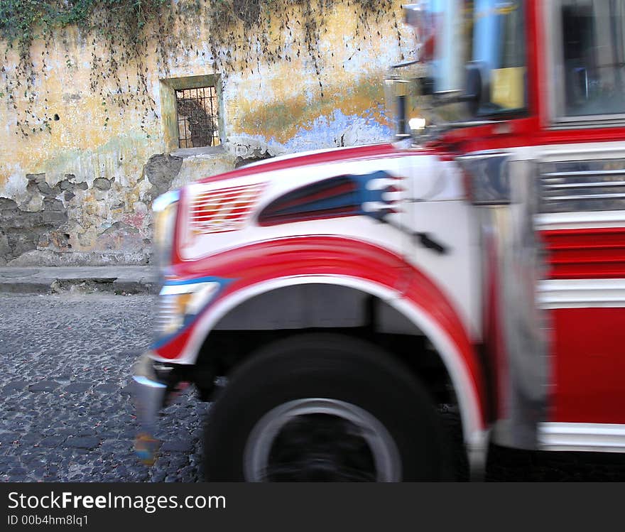 Red bus in motion in antigua