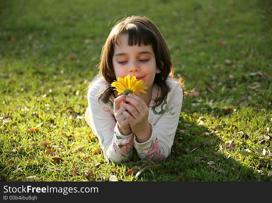 Girl Looking At A Flower