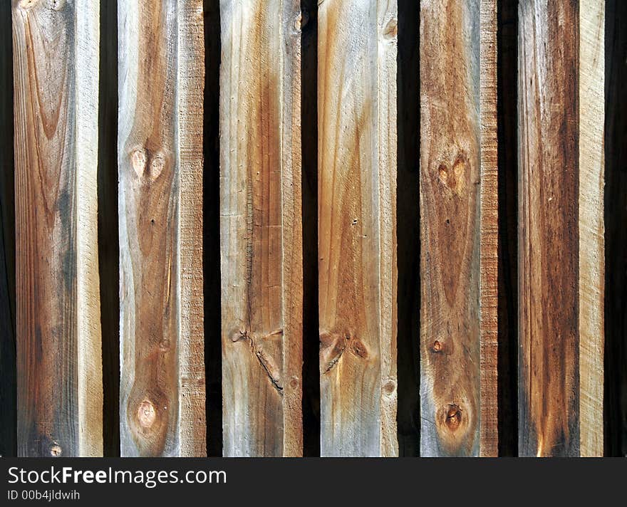 Old Wooden Fence With Weather Marks In Daylight, Background. Old Wooden Fence With Weather Marks In Daylight, Background