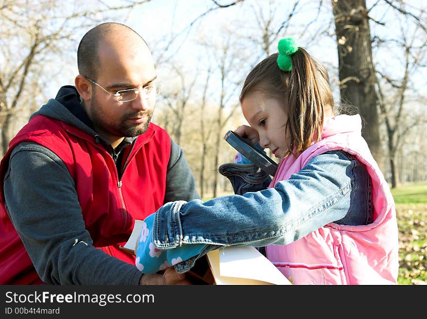 Little pretty child and father reading the book