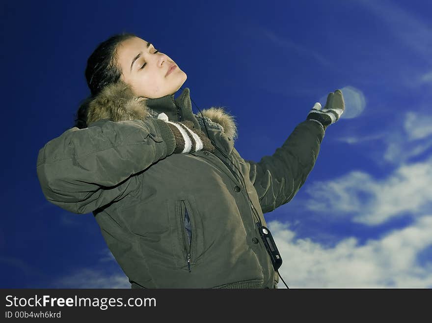 Beautiful young girl listening music