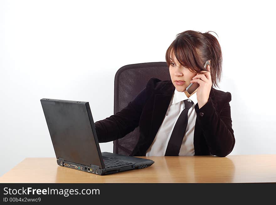 Attractivw woman at desk with laptop on white background. Attractivw woman at desk with laptop on white background