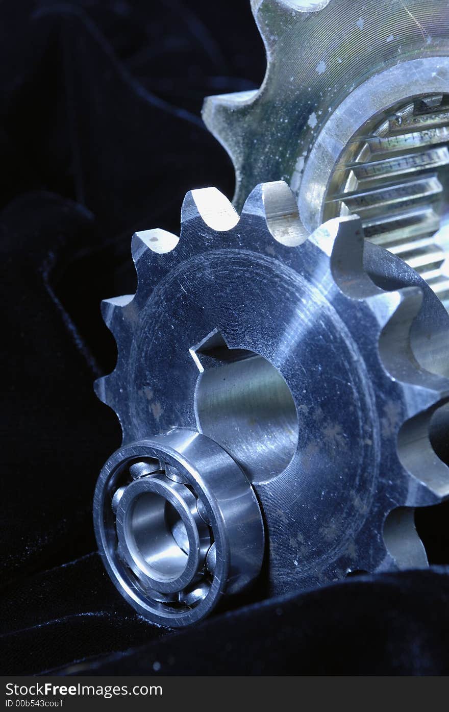 Large and smaller gears in detail against velvet. Large and smaller gears in detail against velvet