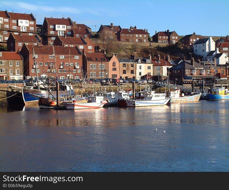 View of Whitby harbour,showing local fishing boats and part of town,on south side of the port