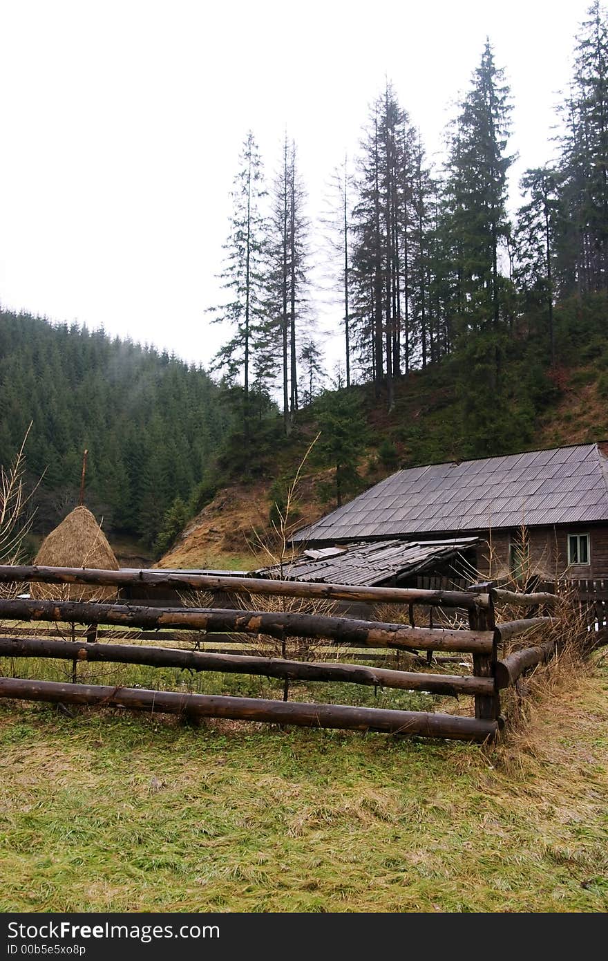 Rustic landscape with cottage and fence