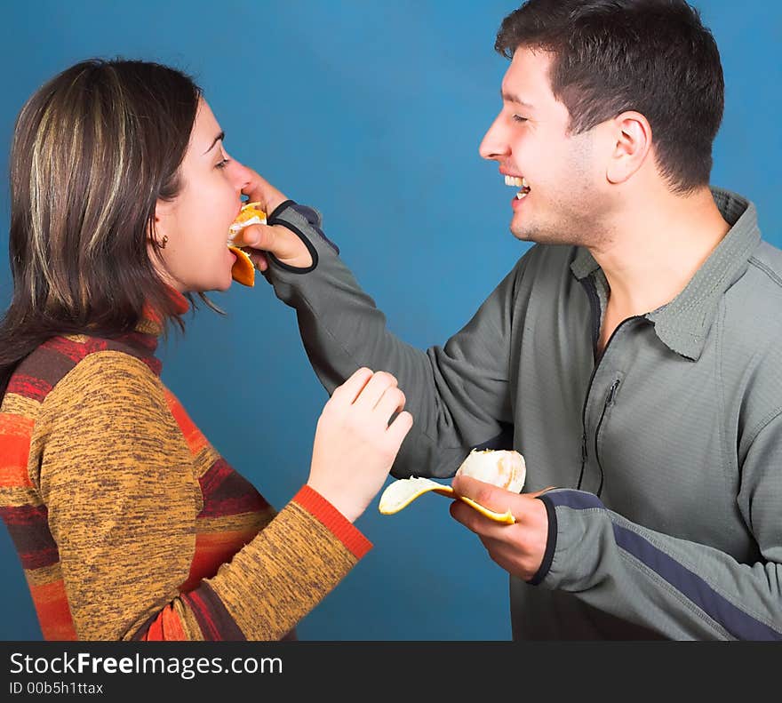 Young couple eat an orange. Young couple eat an orange