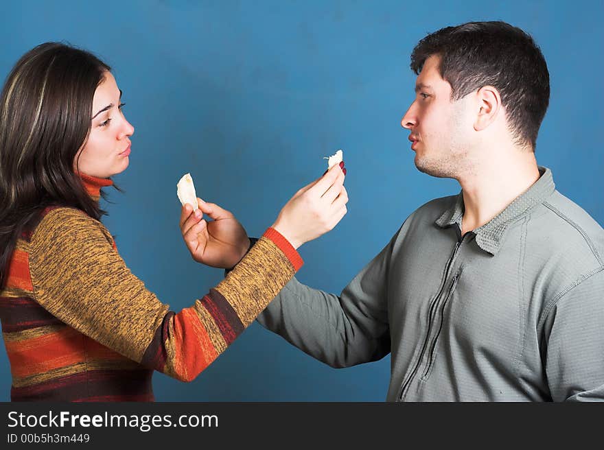 Young couple eat an orange. Young couple eat an orange