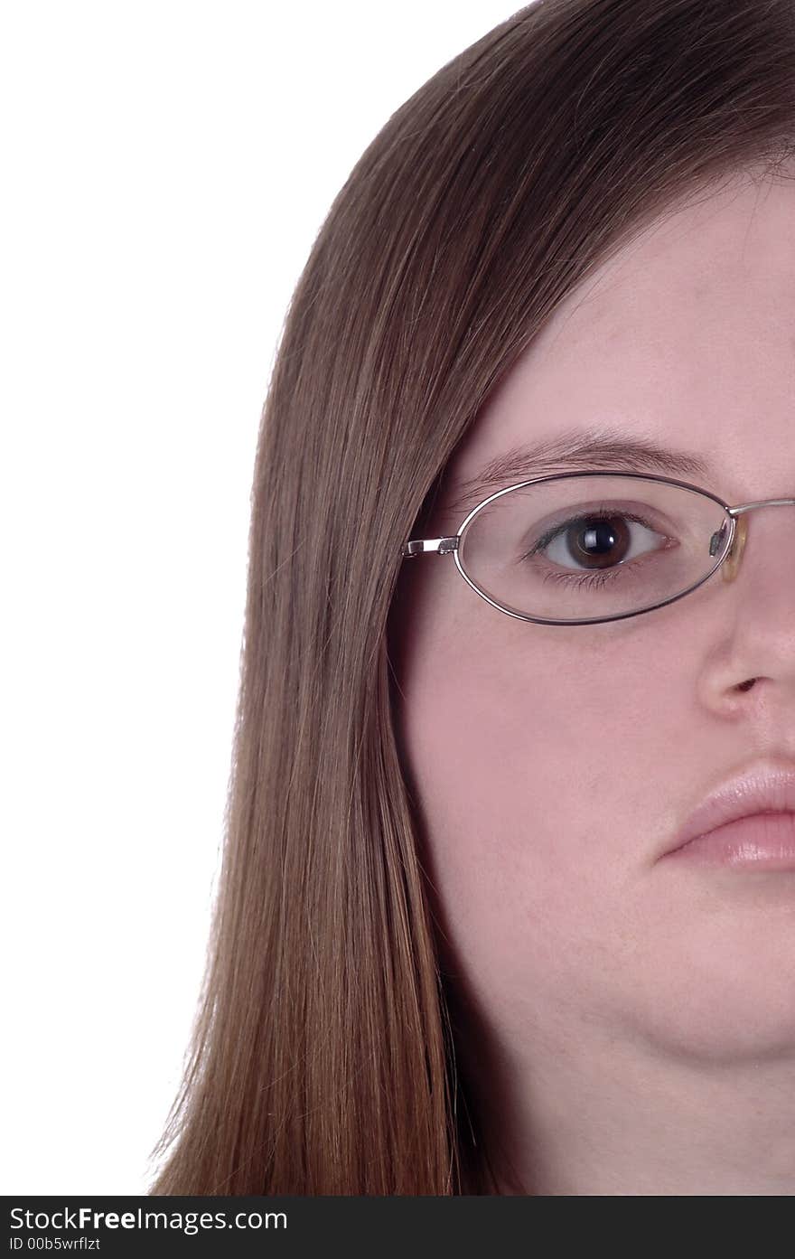 One side of a woman's face against a white background. The woman is wearing glasses and has brown eyes.