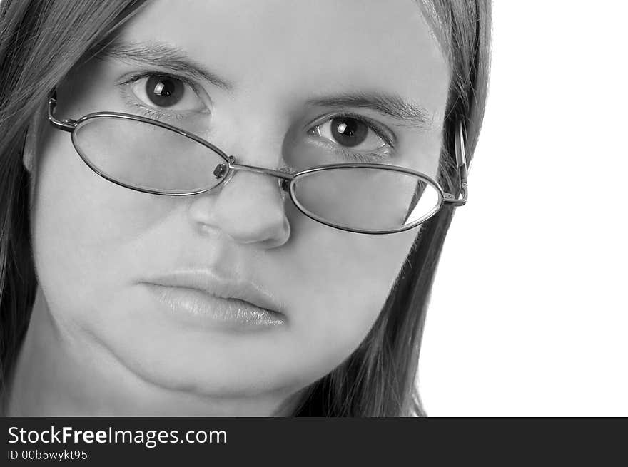 A black and white photo of a stern-looking woman peering over the edge of her glasses. A black and white photo of a stern-looking woman peering over the edge of her glasses.