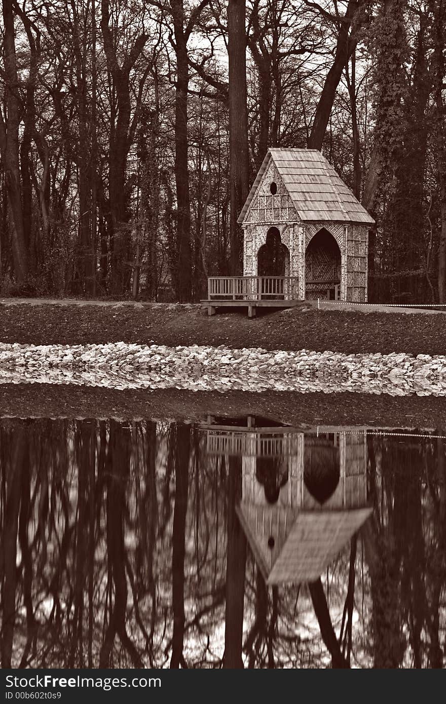 Gazebo in sepia with reflection in water