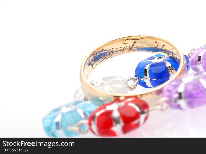 Wedding ring and colourfull beads.