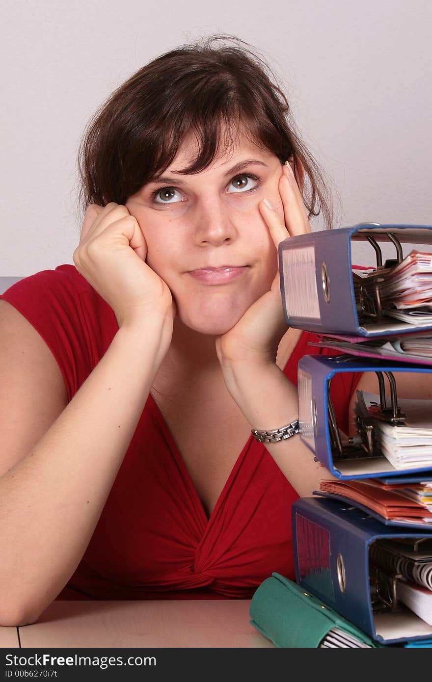 A young beautiful woman is stressed because of the work piling up. A young beautiful woman is stressed because of the work piling up.