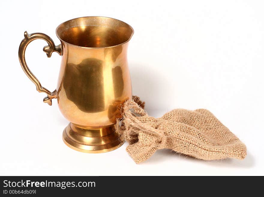 A brass cup and hessian bag. A brass cup and hessian bag.