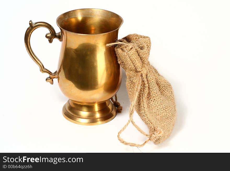 A brass cup and hessian bag. A brass cup and hessian bag.