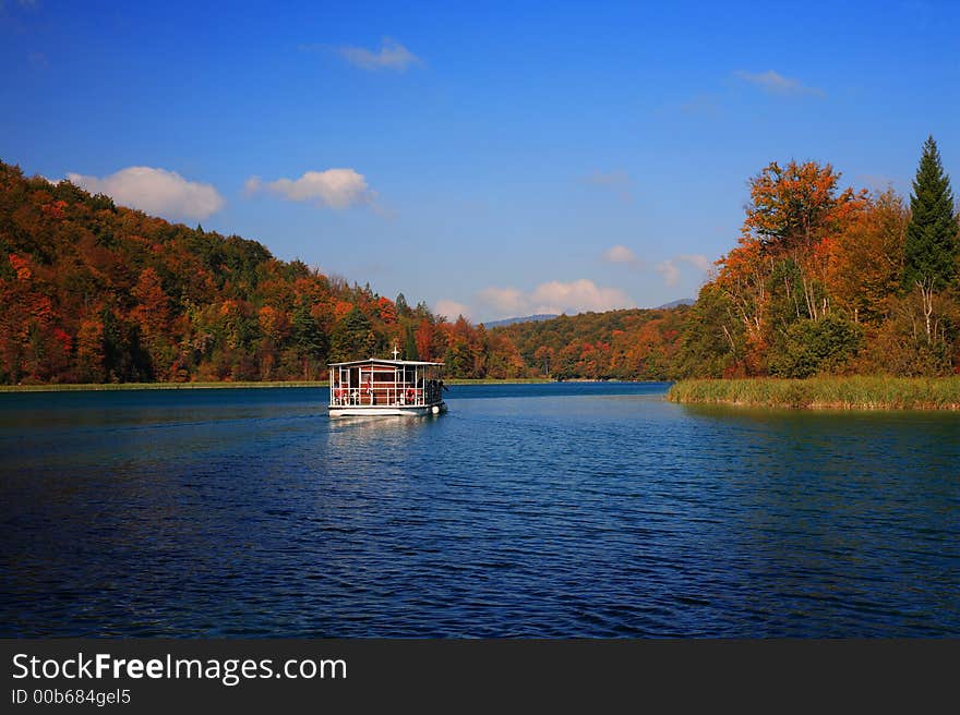 Autumn mountain lake with boat