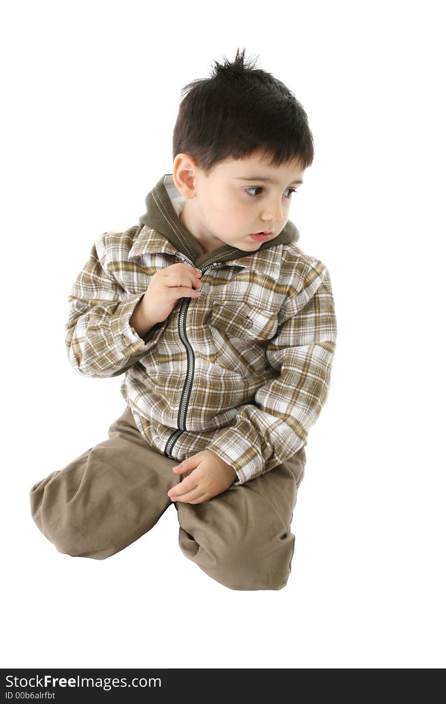 Toddler boy with disinterested expression; wearing green hooded jacket over white. Toddler boy with disinterested expression; wearing green hooded jacket over white