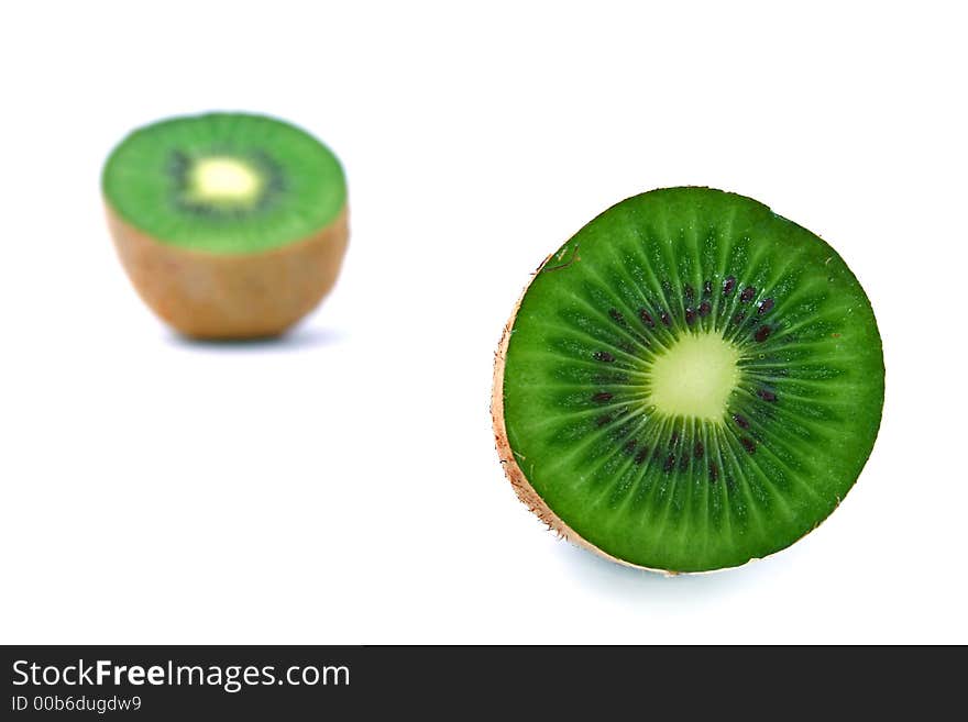 Close-up of slices of green kiwi fruit with seeds inside