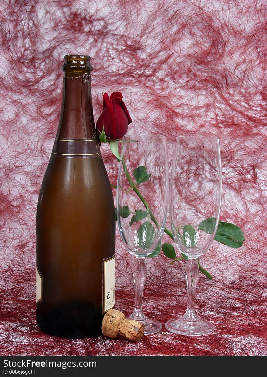 Champagne bottle, cups and red rose for valentine day