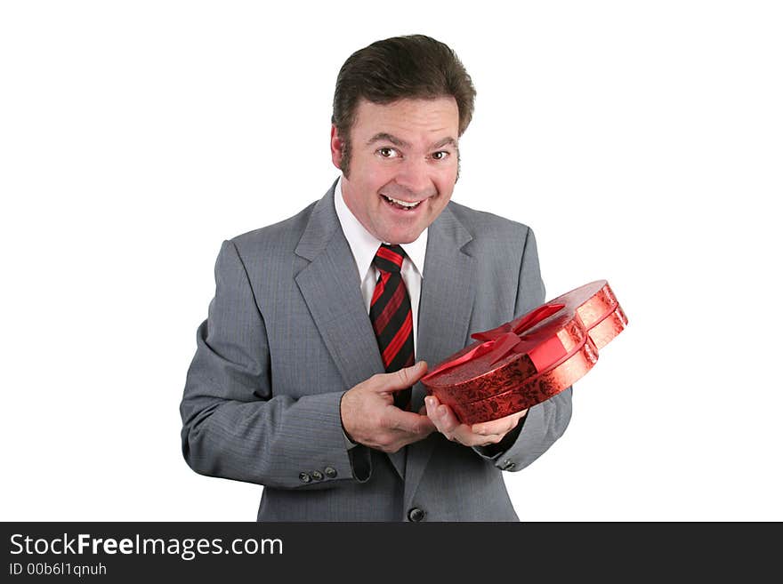 A handsome man in a suit surprised by Valentines candy. Isolated on white. A handsome man in a suit surprised by Valentines candy. Isolated on white.