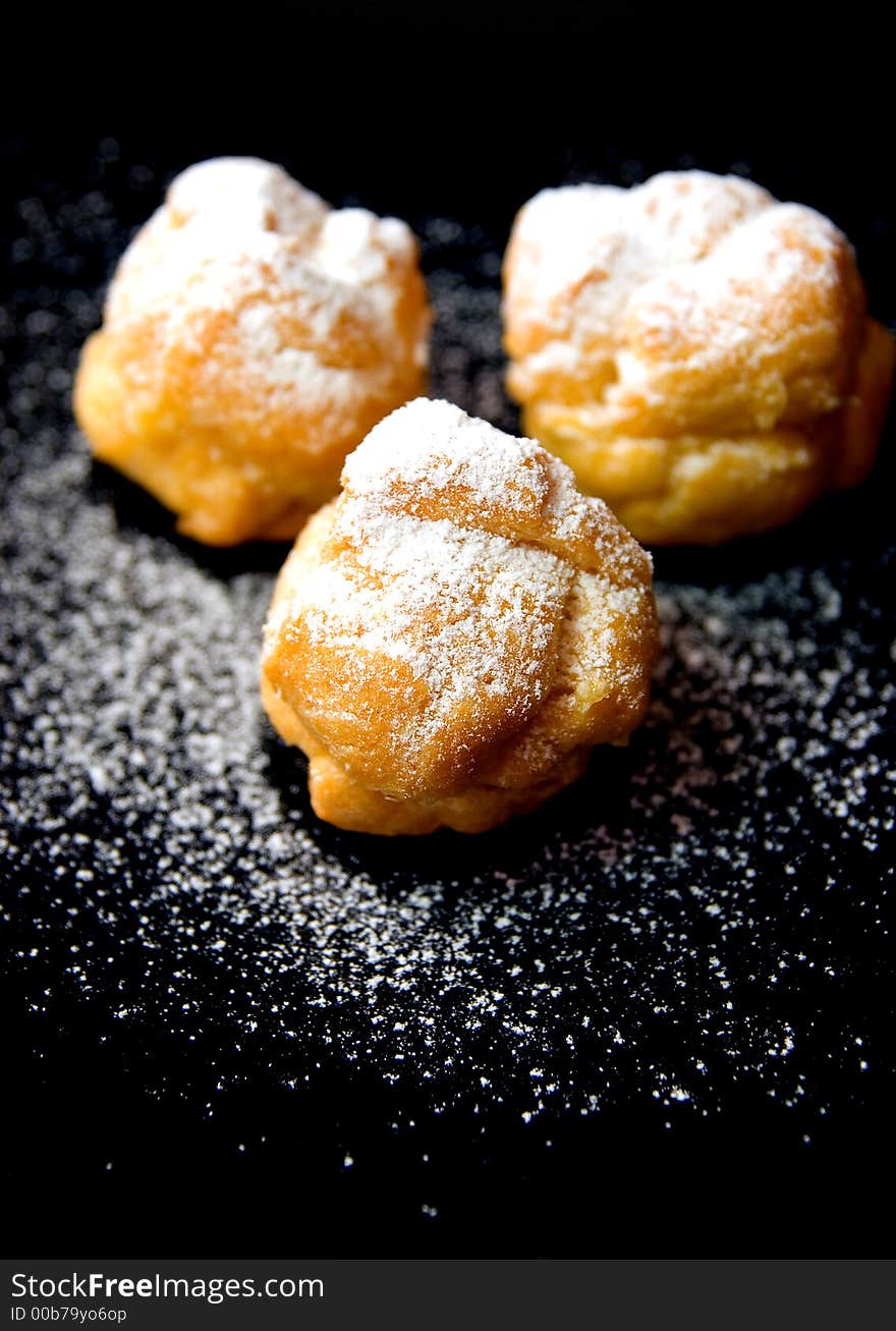 Three Desserts On Black Plate