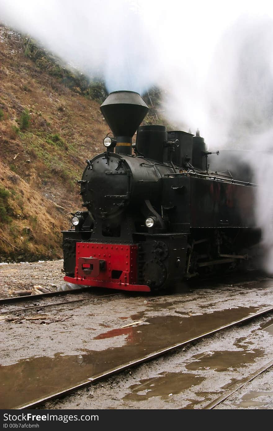 Steam railway vintage locomotive through the mountains