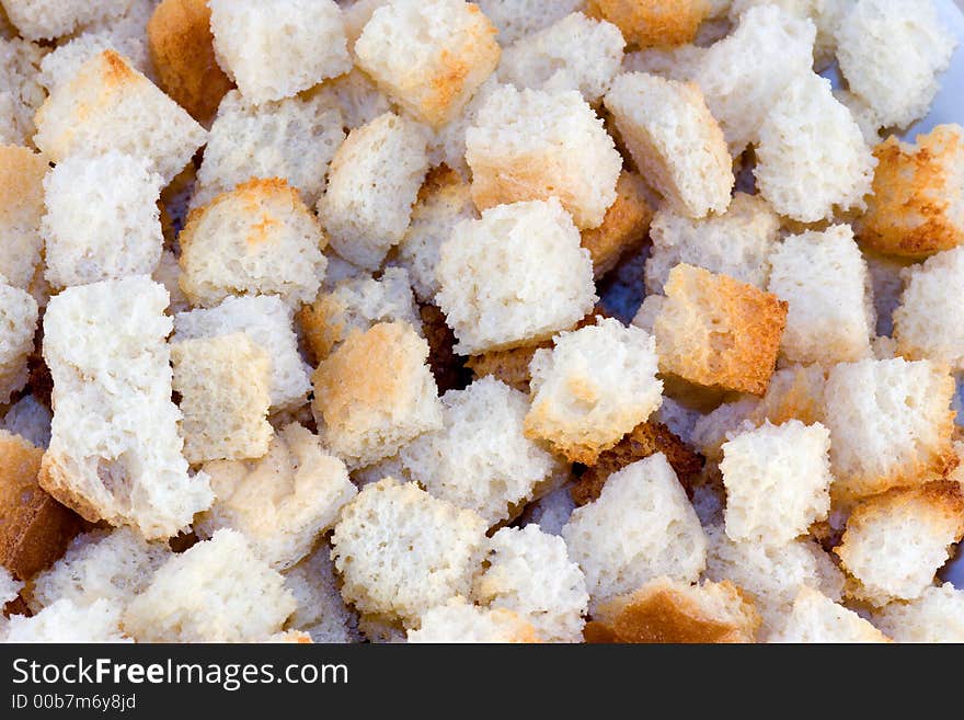 Bread croutons seen as a macro close-up background. Bread croutons seen as a macro close-up background