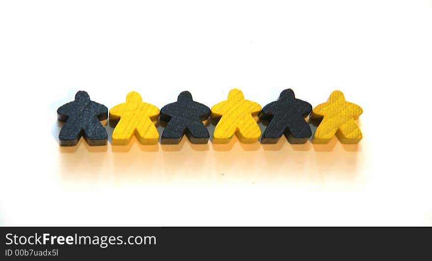 The little mans of different colors on the white table