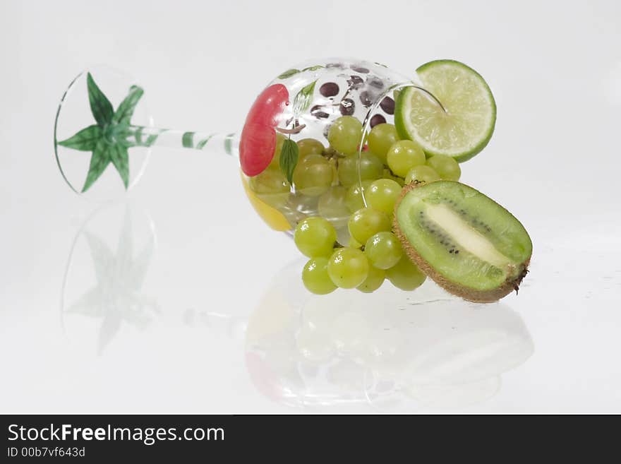 Kiwi, grapes and lime in a fancy glass. Kiwi, grapes and lime in a fancy glass