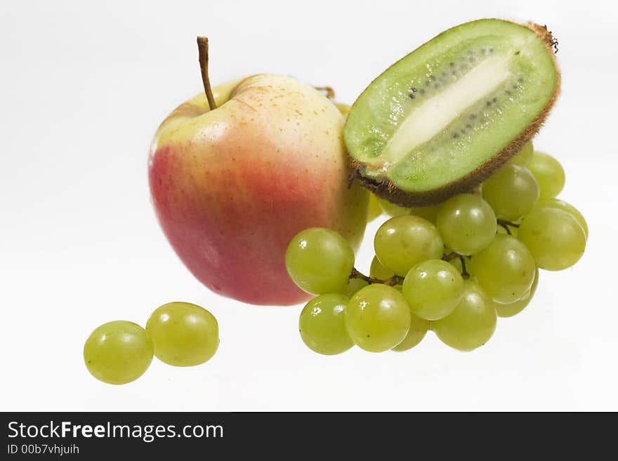 Apple, kiwi and grapes over white background. Apple, kiwi and grapes over white background