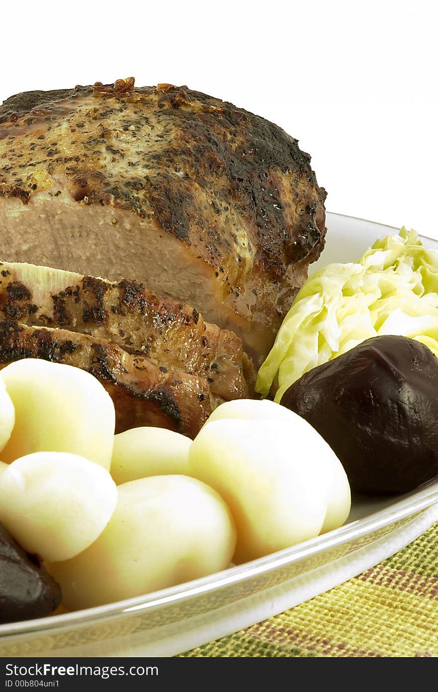 Pork tenderloin roast served with a variety of tender vegetables.