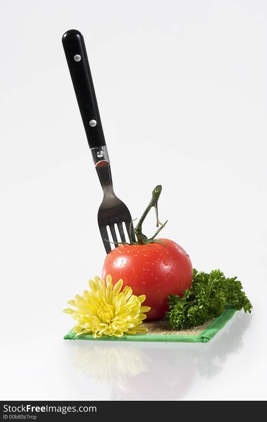 Tomatoes, yellow flower, parsley and decanter with water over white. Tomatoes, yellow flower, parsley and decanter with water over white