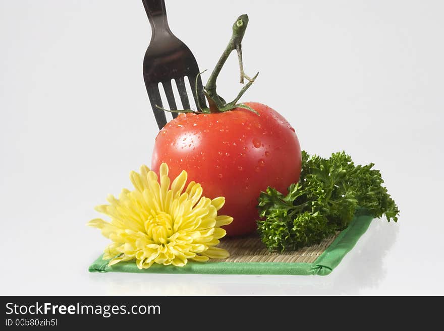 Tomatoes, yellow flower, parsley and decanter with water over white. Tomatoes, yellow flower, parsley and decanter with water over white