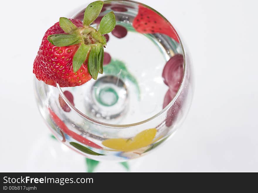 A glass and strawberry, close up. A glass and strawberry, close up