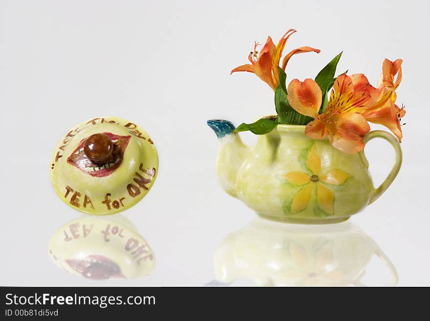 Green fancy kettle with flowers over white background