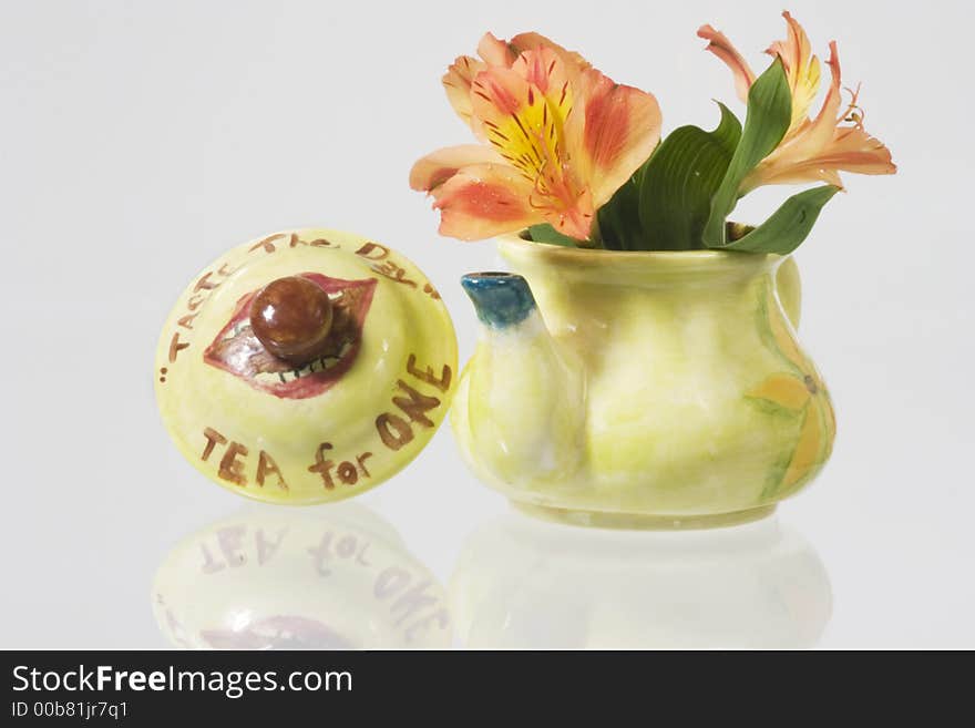 Green fancy kettle with flowers over white background