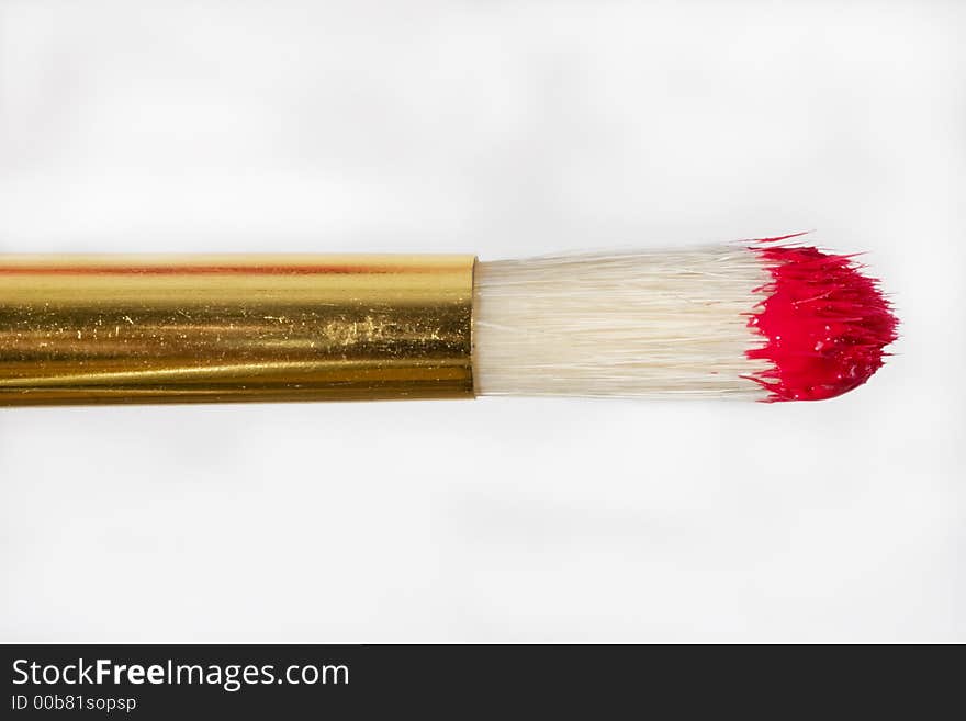 Paint brush close up with red color