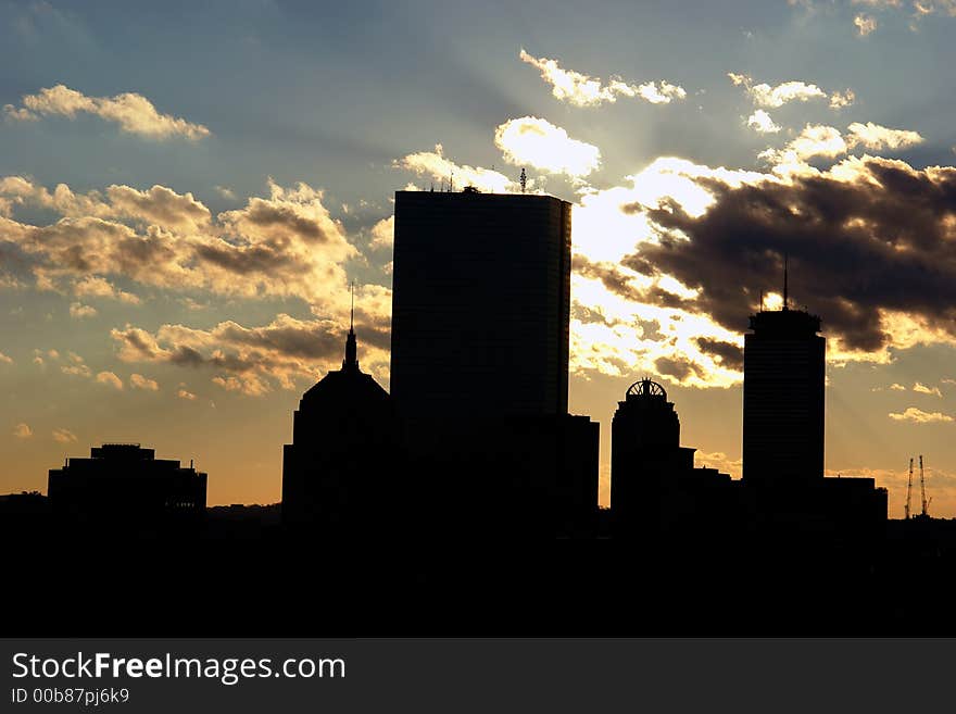 Boston skyline silhouetted against sky