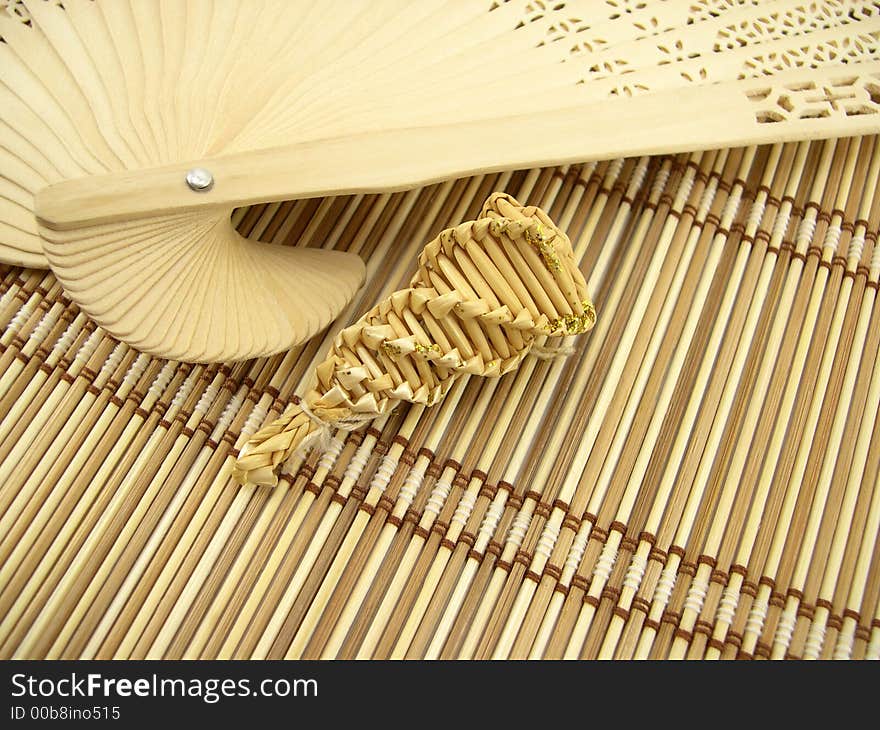 Graceful wooden fan and bamboo napkin. Graceful wooden fan and bamboo napkin